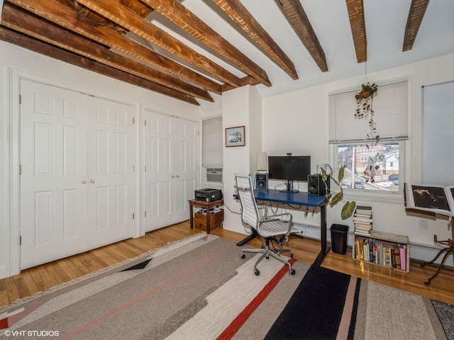 office with beam ceiling and wood finished floors