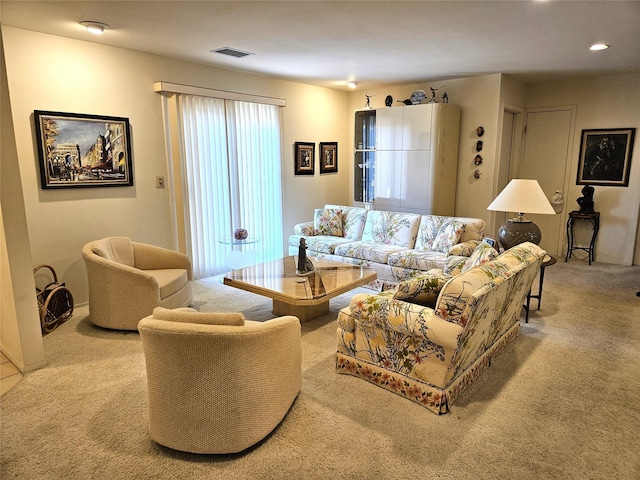 living area featuring light carpet and visible vents