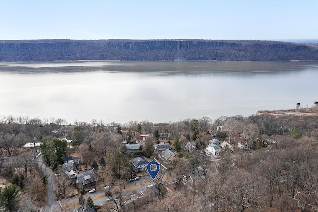 aerial view with a wooded view and a water view