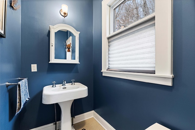 bathroom with baseboards and a sink