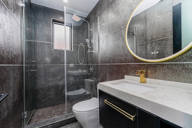 full bathroom featuring a stall shower, vanity, toilet, and tile walls