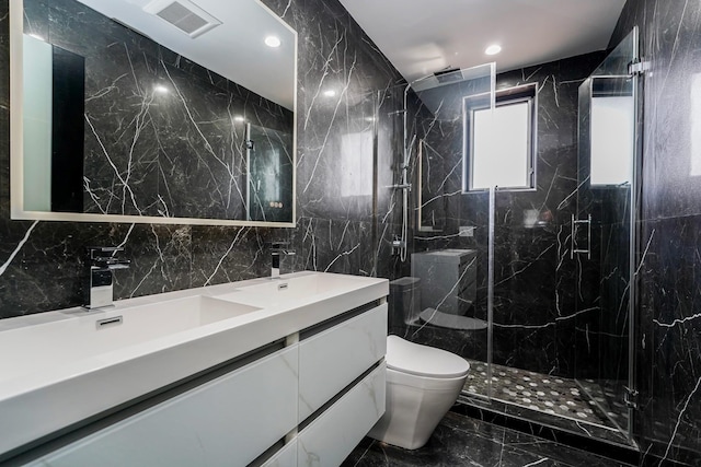 full bathroom with toilet, marble finish floor, double vanity, and a sink