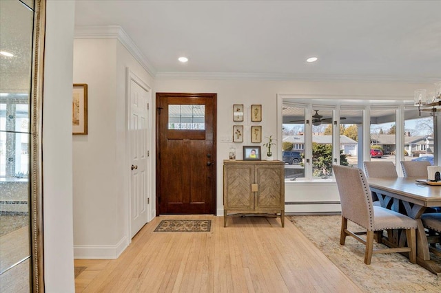 foyer featuring a baseboard heating unit, ornamental molding, light wood-style flooring, and recessed lighting