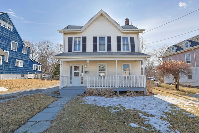 view of front of home with a porch and a chimney