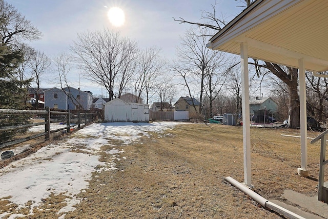 view of yard with a residential view, fence, and an outdoor structure