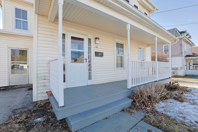 view of exterior entry with a porch