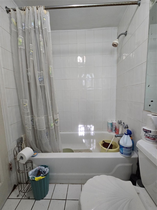 bathroom featuring shower / bath combination with curtain, tile patterned flooring, tile walls, and toilet