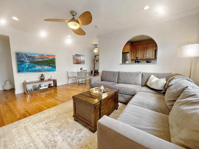 living area with recessed lighting, ceiling fan, crown molding, and wood finished floors