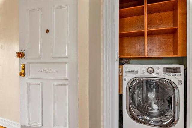 laundry room featuring laundry area and washer / dryer