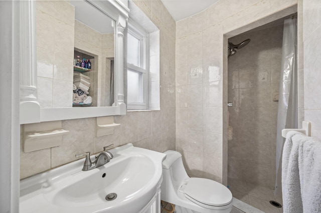 bathroom featuring toilet, tile walls, a shower stall, and vanity