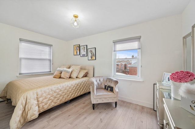 bedroom featuring light wood-type flooring and baseboards