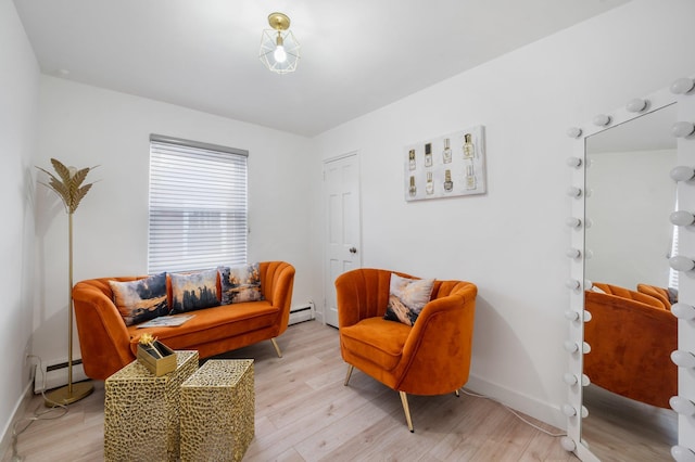 sitting room featuring light wood finished floors, a baseboard radiator, baseboards, and baseboard heating