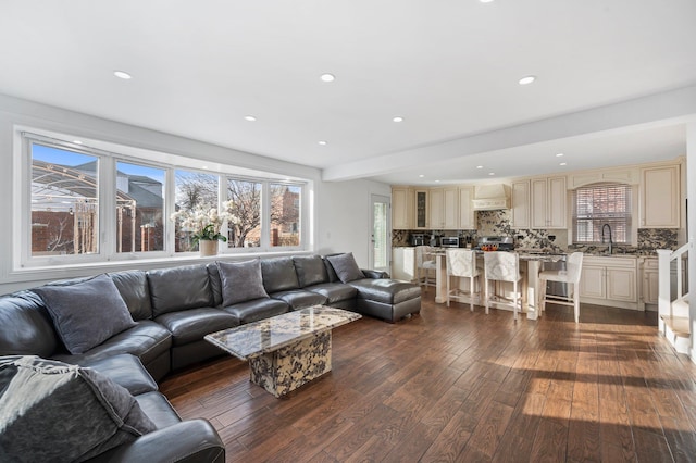 living area featuring recessed lighting, dark wood-style flooring, and plenty of natural light