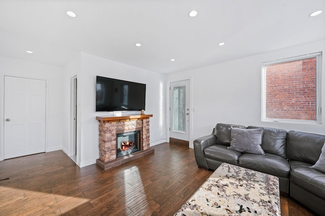 living area with a fireplace, baseboards, dark wood-style flooring, and recessed lighting