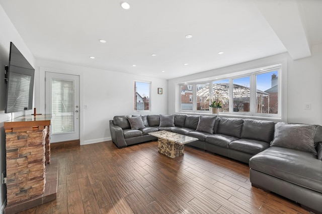 living area with dark wood-style floors, baseboards, and recessed lighting