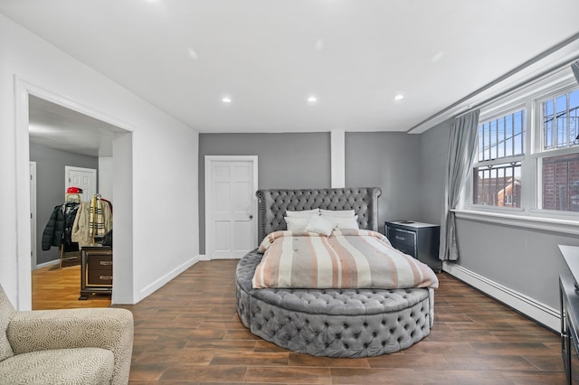 bedroom featuring dark wood-type flooring, a baseboard radiator, recessed lighting, and baseboards