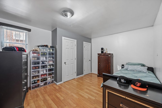 bedroom featuring light wood-type flooring and baseboards