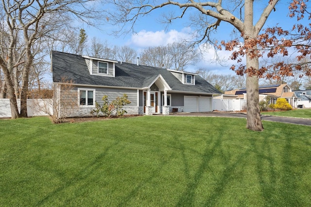 view of front of house with aphalt driveway, an attached garage, fence, stone siding, and a front lawn