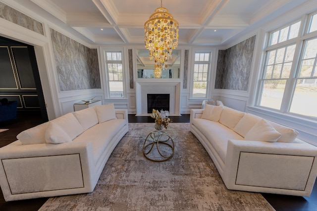 living room with a fireplace with flush hearth, beam ceiling, coffered ceiling, and a decorative wall