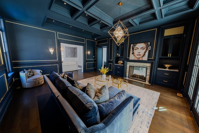 cinema with ornamental molding, coffered ceiling, a multi sided fireplace, and a decorative wall