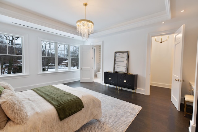 bedroom with baseboards, dark wood-style flooring, a tray ceiling, crown molding, and a notable chandelier