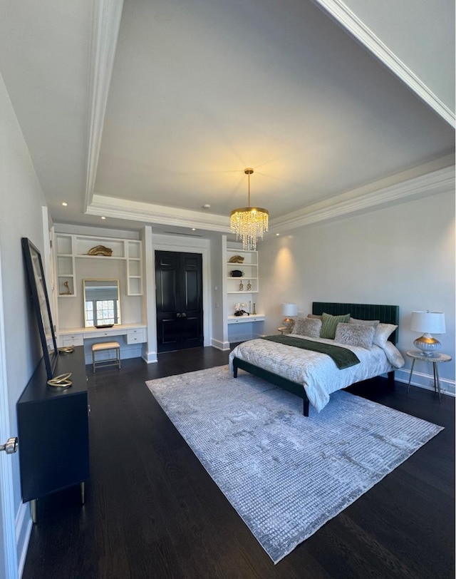 bedroom featuring dark wood-style floors, a tray ceiling, an inviting chandelier, ornamental molding, and baseboards