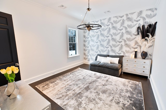 sitting room featuring visible vents, baseboards, ornamental molding, dark wood-style floors, and wallpapered walls