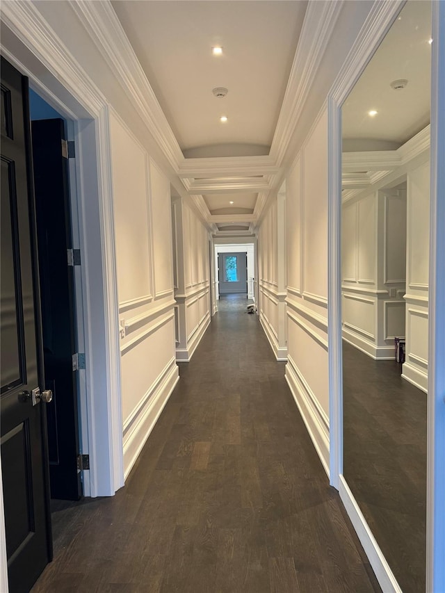 hallway featuring ornamental molding, dark wood finished floors, a decorative wall, and recessed lighting