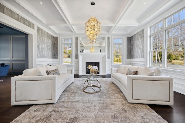 living area with a decorative wall, a notable chandelier, and a healthy amount of sunlight