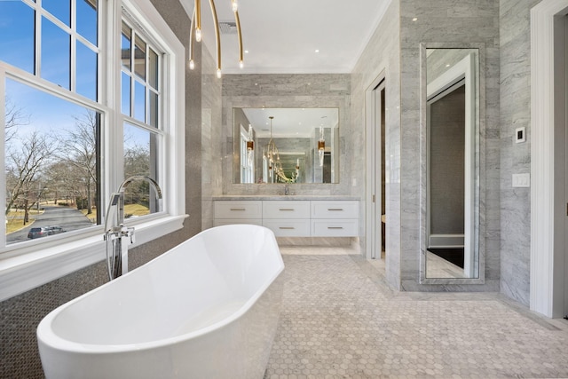 full bathroom featuring a soaking tub, tile patterned floors, vanity, and visible vents