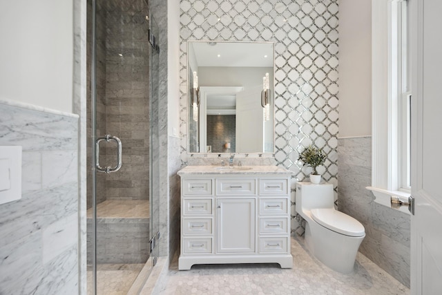 bathroom featuring vanity, a wainscoted wall, toilet, tile walls, and a stall shower