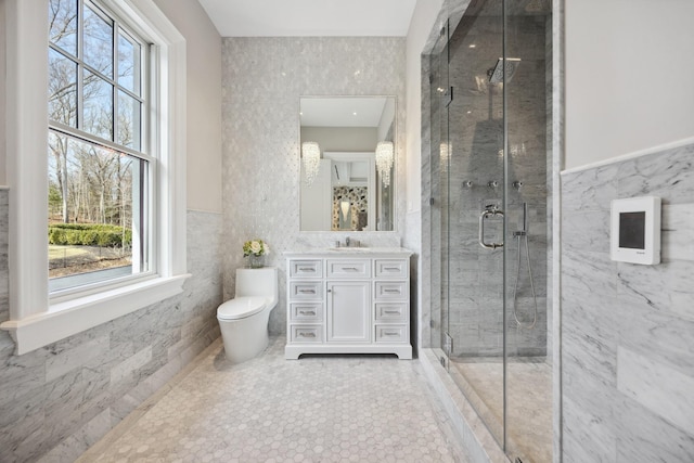 bathroom with tile walls, plenty of natural light, and a stall shower
