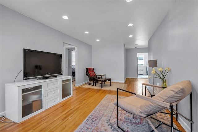 interior space featuring baseboards, light wood-type flooring, and recessed lighting