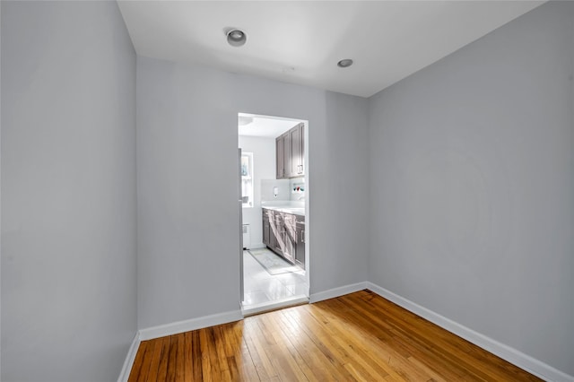 spare room with light wood finished floors and baseboards