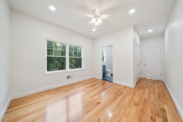 unfurnished room featuring light wood-style flooring, visible vents, baseboards, and recessed lighting