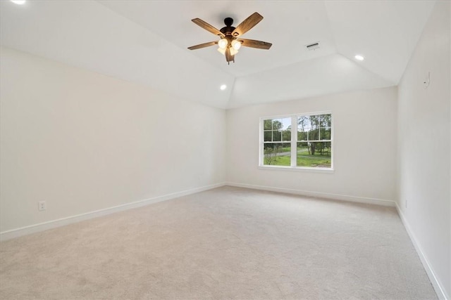 empty room with recessed lighting, light colored carpet, visible vents, vaulted ceiling, and baseboards