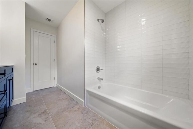 full bathroom with washtub / shower combination, visible vents, vanity, and baseboards