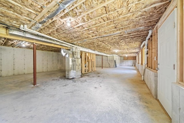 unfinished basement featuring heating unit