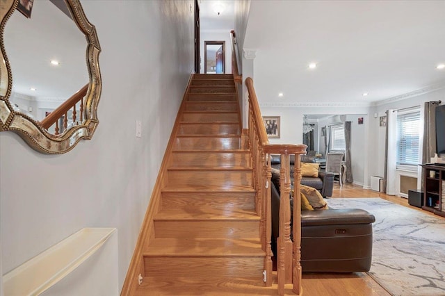 staircase featuring ornamental molding, recessed lighting, wood finished floors, and baseboards