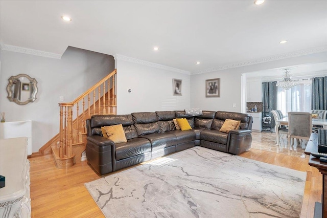 living area featuring stairs, crown molding, light wood-style floors, a chandelier, and recessed lighting