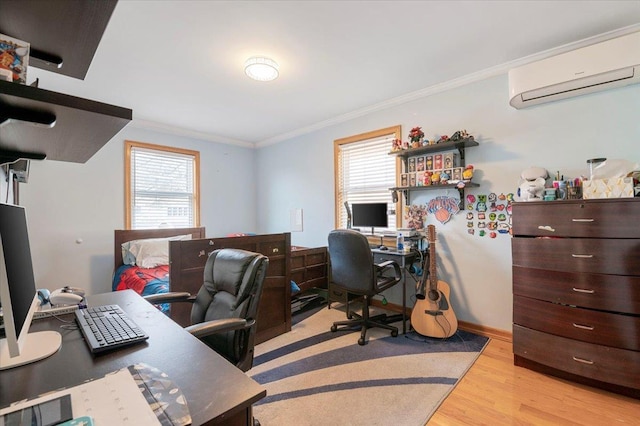 home office with an AC wall unit, ornamental molding, and light wood-style flooring