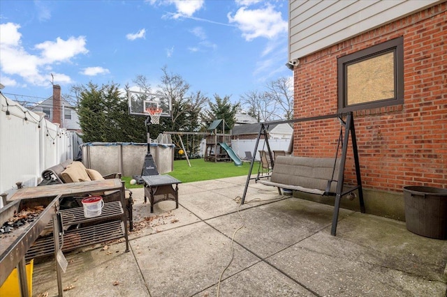 view of patio / terrace featuring a fenced in pool, a playground, a fenced backyard, and an outdoor hangout area