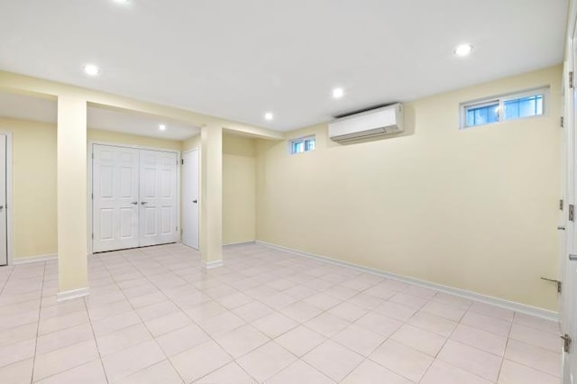 basement with recessed lighting, baseboards, and a wall mounted AC