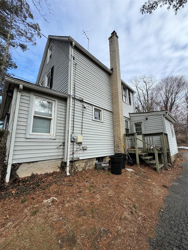 rear view of house featuring a chimney