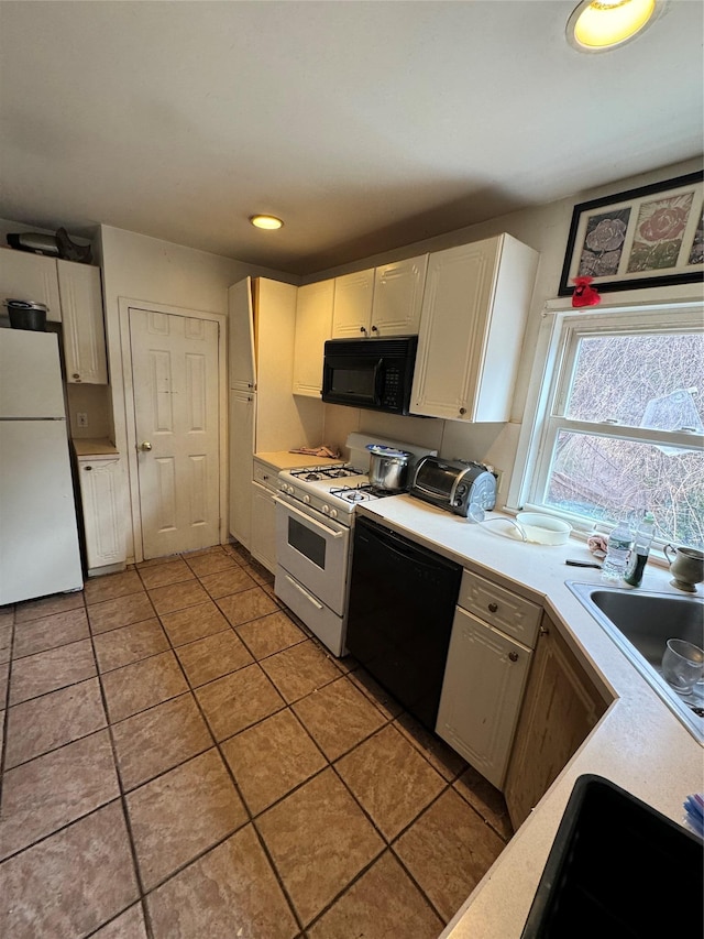 kitchen featuring black appliances, light tile patterned floors, white cabinetry, and light countertops