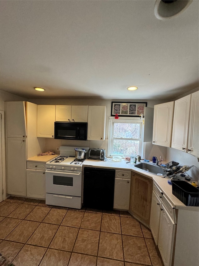 kitchen featuring black appliances, tile patterned flooring, light countertops, and a sink