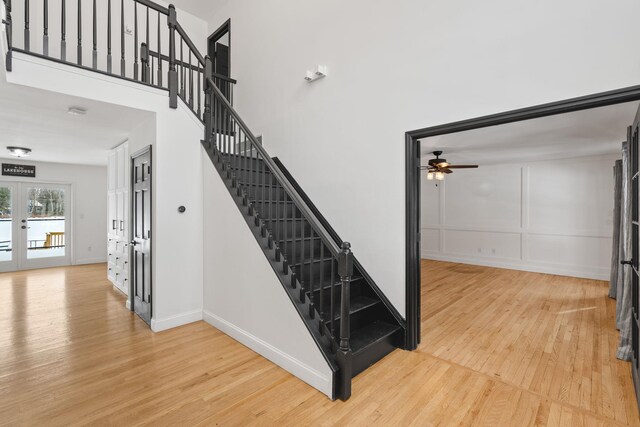 61 Surrey St, Rock Hill, NY 12775 - stairway with french doors, wood finished floors, ceiling fan, and baseboards