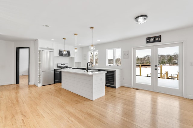 61 Surrey St, Rock Hill, NY 12775 - kitchen with stainless steel appliances, wine cooler, light countertops, light wood finished floors, and recessed lighting