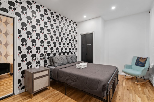 bedroom with baseboards, light wood-type flooring, and recessed lighting