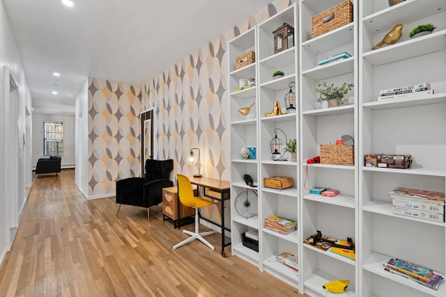 interior space featuring baseboards, a baseboard heating unit, wood finished floors, and recessed lighting